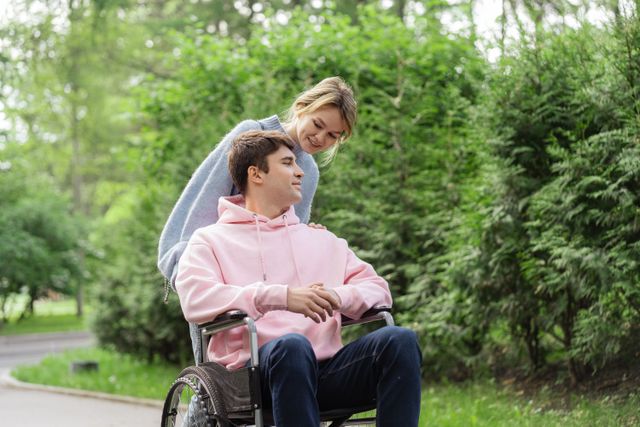 Happy couple enjoys a moment together in a park, highlighting love and inclusion.